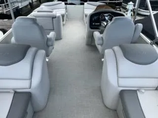 Slide: The Image of 2018 Avalon Catalina 2385QL boat interior with gray seating and steering console. - 7