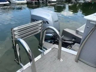 Slide: The Image of 2018 Avalon Catalina 2385QL boat with Honda 150 engine at dock. - 8