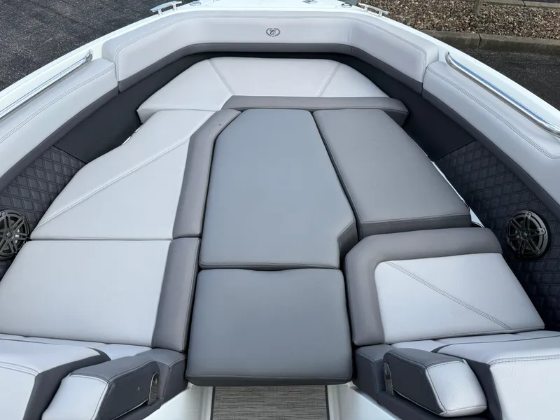 Slide: The Image of 2022 Cobalt R8 boat interior with gray cushioned seating and speakers. - 11