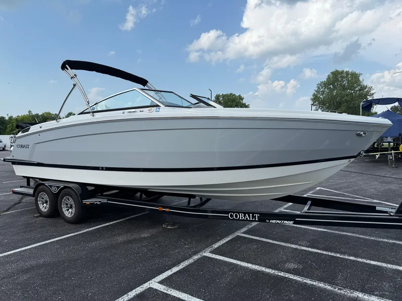 Slide: The Image of 2022 Cobalt R8 boat on trailer in parking lot under cloudy sky. - 3