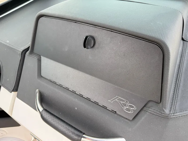 Slide: The Image of Dashboard of 2022 Cobalt R8 boat with storage compartment and handle. - 33