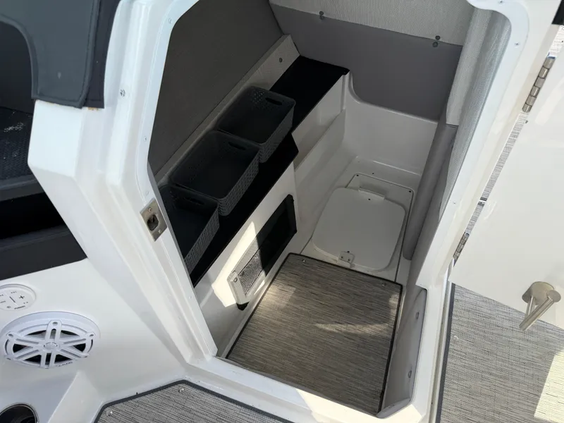 Slide: The Image of Interior cabin of 2022 Cobalt R8 boat with storage compartments and carpeted flooring. - 34