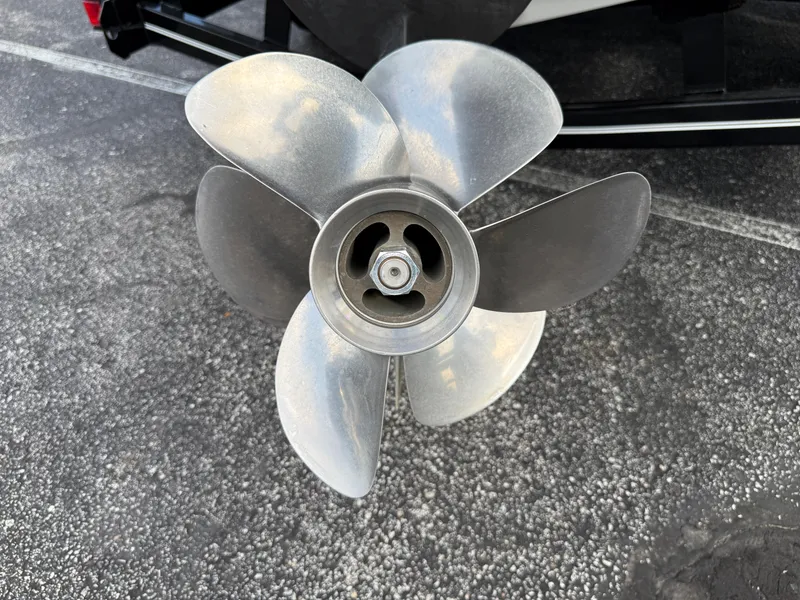 Slide: The Image of Close-up of a 2022 Cobalt R8 boat propeller on asphalt surface. - 7