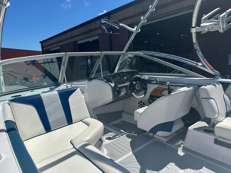 Slide: The Image of 2009 Nautique Super Air 210 boat interior with sleek dashboard and comfortable seating. - 12