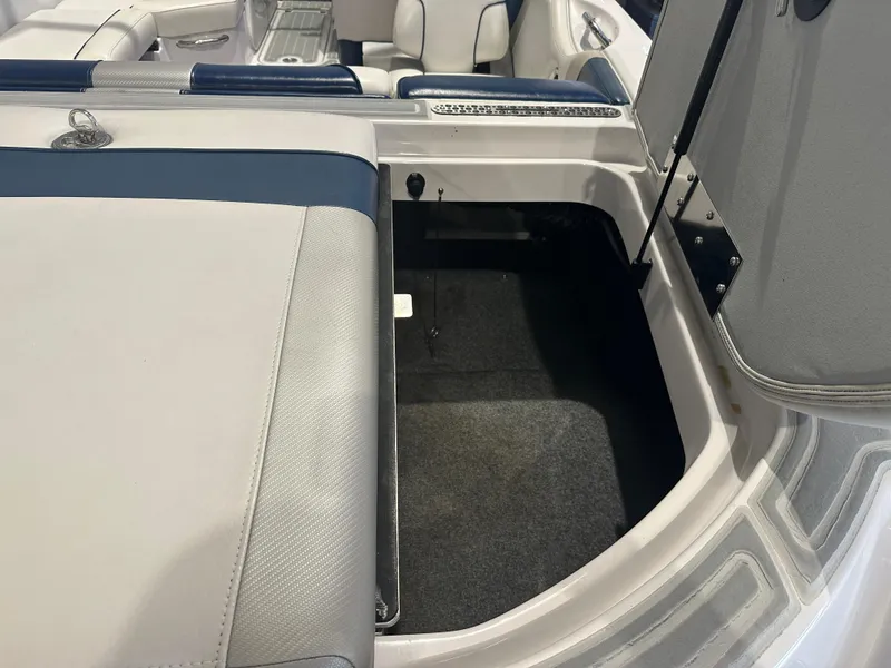 Slide: The Image of 2009 Nautique Super Air 210 boat interior storage compartment with open hatch. - 15