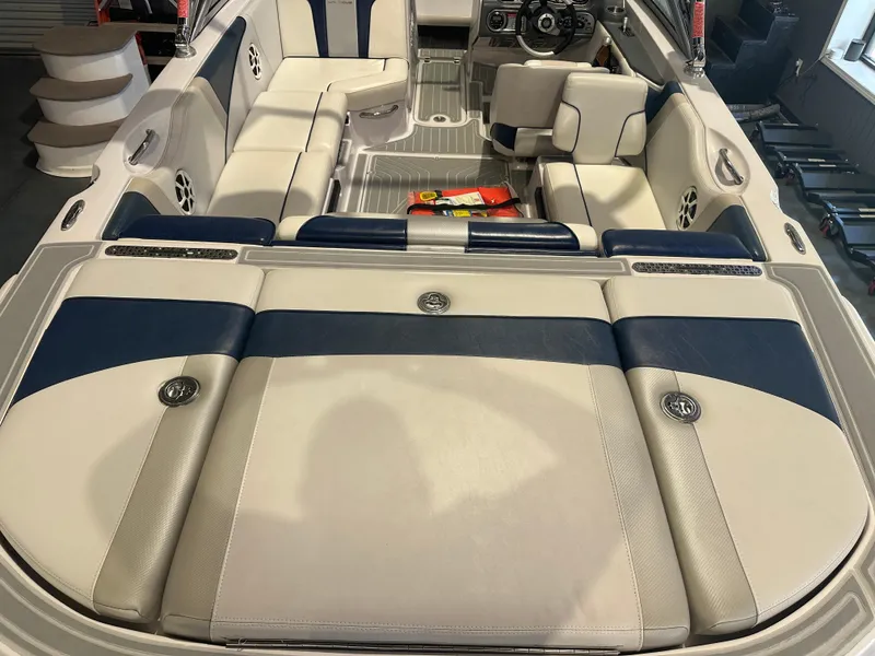 Slide: The Image of 2009 Nautique Super Air 210 boat interior with blue and white seating. - 18