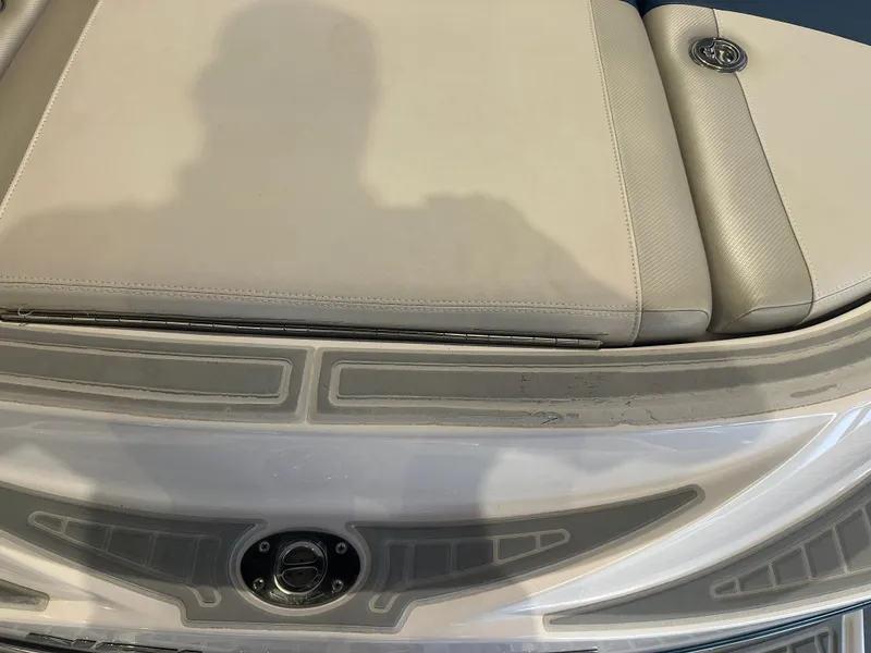 Slide: The Image of 2009 Nautique Super Air 210 boat interior with beige seating and sleek design. - 19