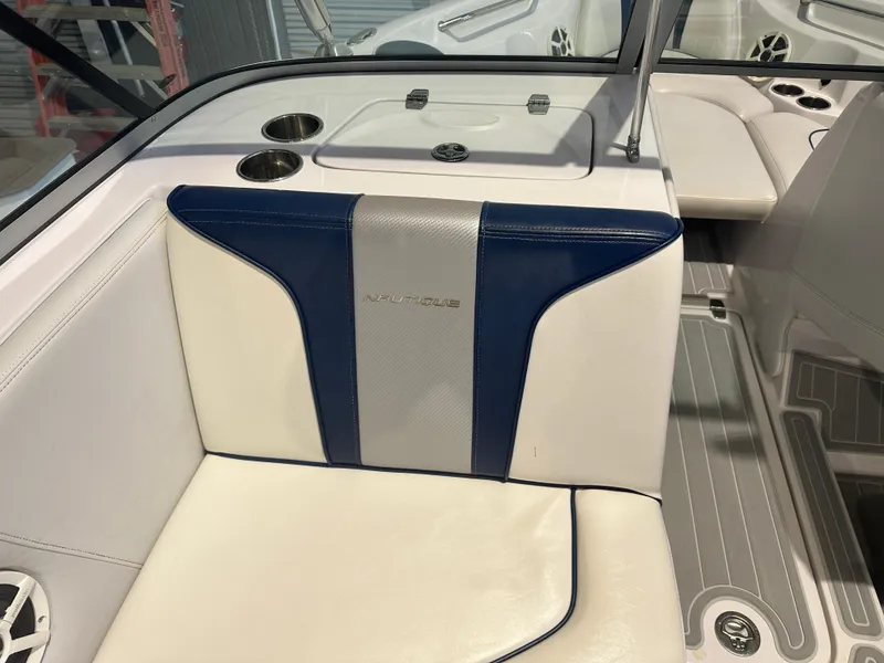 Slide: The Image of 2009 Nautique Super Air 210 boat interior with blue and white seating. - 21