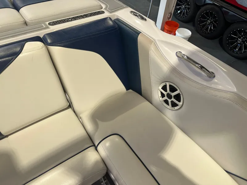 Slide: The Image of 2009 Nautique Super Air 210 boat interior with white and blue seating and speaker. - 23
