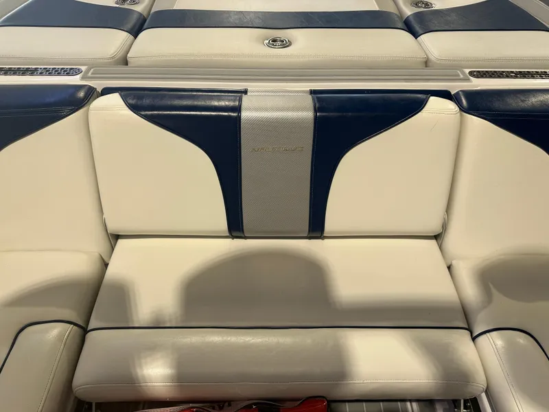 Slide: The Image of 2009 Nautique Super Air 210 boat interior with blue and white seating. - 24