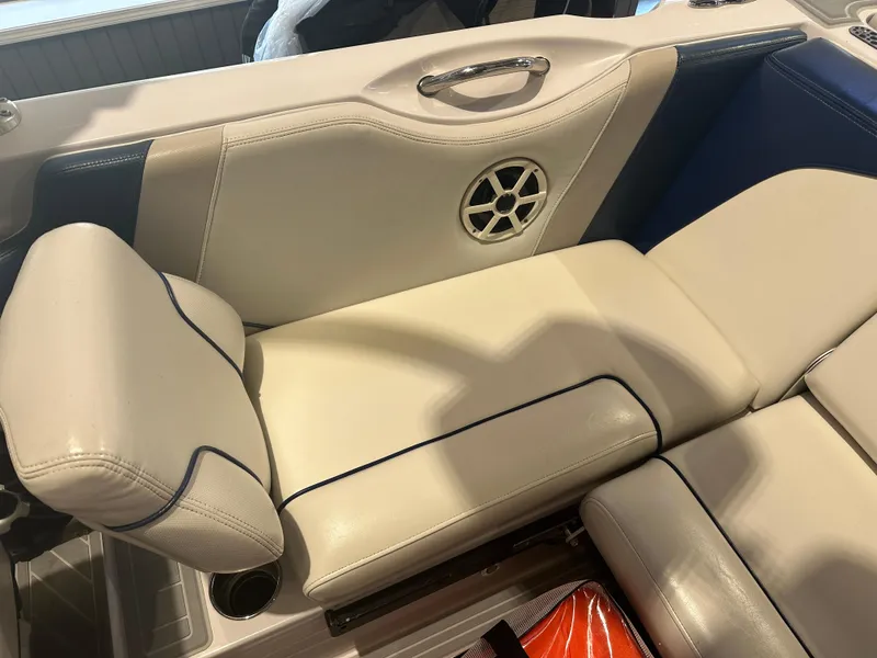 Slide: The Image of 2009 Nautique Super Air 210 boat interior with beige seating and speaker detail. - 25