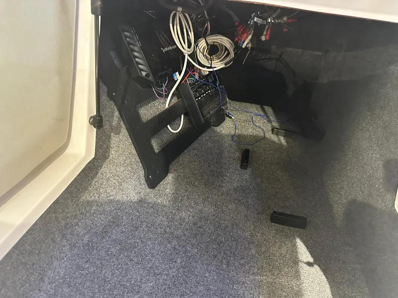 Slide: The Image of Interior view of a 2009 Nautique Super Air 210 boat showing wiring and equipment. - 28