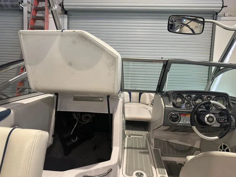 Slide: The Image of 2009 Nautique Super Air 210 boat interior with dashboard and seating area. - 29