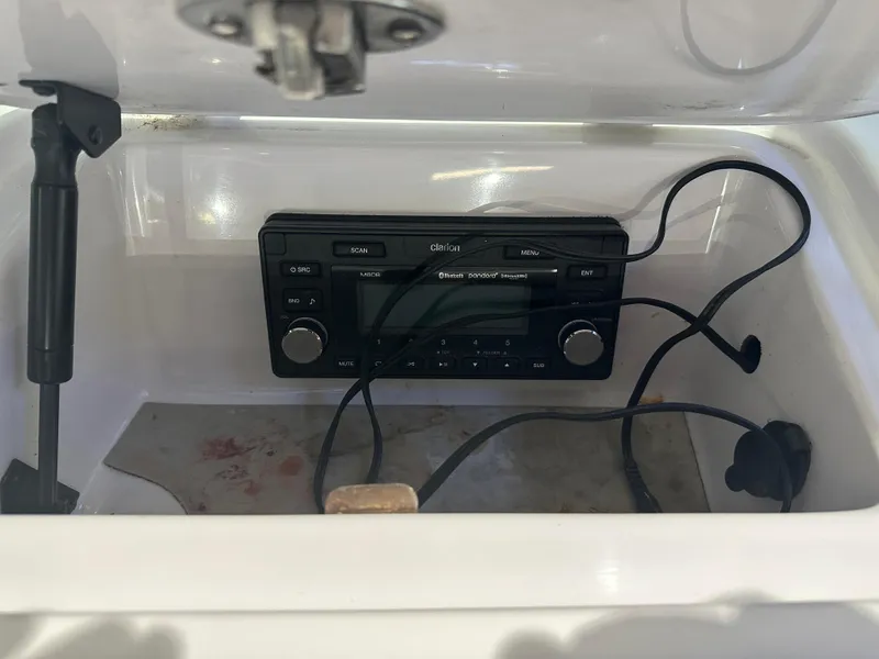 Slide: The Image of 2009 Nautique Super Air 210 stereo system with cables inside a compartment. - 30