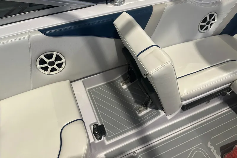 Slide: The Image of 2009 Nautique Super Air 210 interior with white and blue seating, featuring built-in speakers. - 32