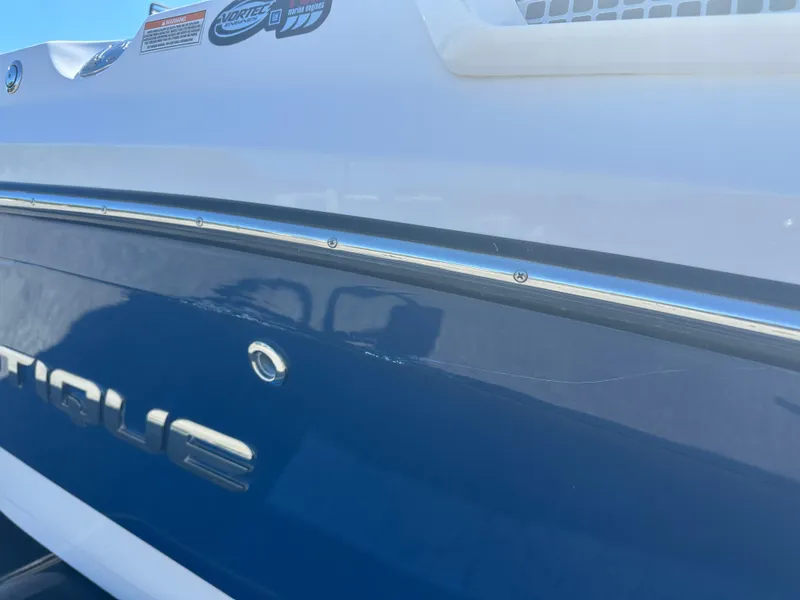 Slide: The Image of 2009 Nautique Super Air 210 boat, blue and white exterior, close-up view. - 4