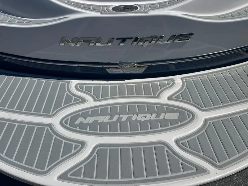 Slide: The Image of 2009 Nautique Super Air 210 boat deck with logo and textured surface. - 9