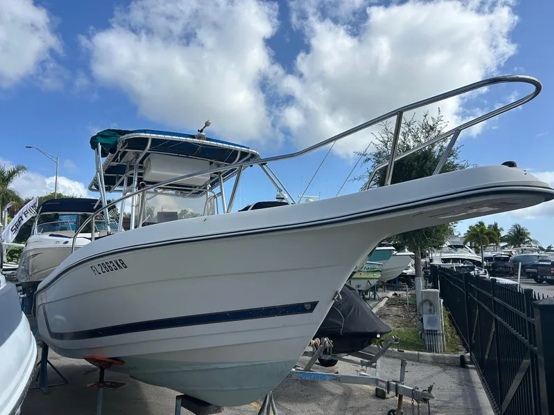 The Image of 1998 Cobia 224 CC boat on trailer under blue sky with clouds. - 0