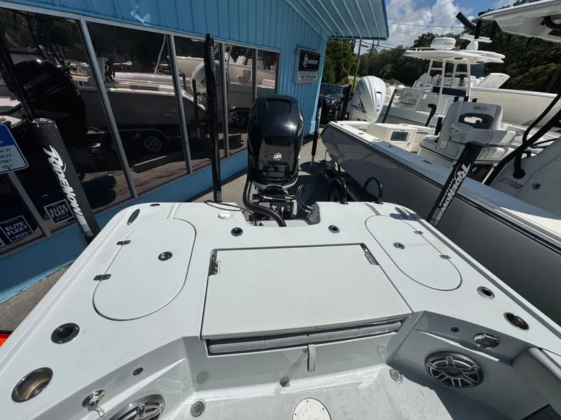 Slide: The Image of 2023 Blazer 2700 HYBRID BAY boat with motor, docked near blue building. - 11