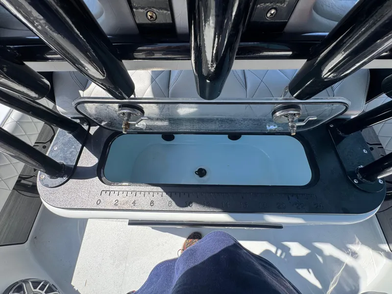 Slide: The Image of 2023 Blazer 2700 HYBRID BAY boat interior with open storage compartment and measurement markings. - 15