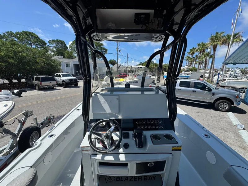 Slide: The Image of 2023 Blazer 2700 HYBRID BAY boat interior with steering console and controls. - 16