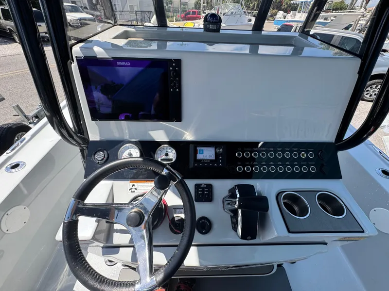 Slide: The Image of 2023 Blazer 2700 HYBRID BAY boat dashboard with steering wheel and control panel. - 17