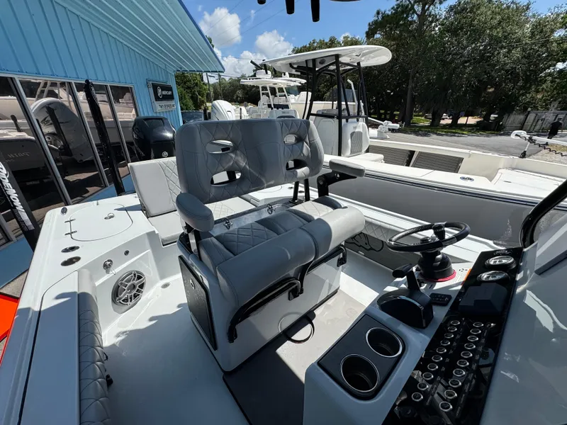 Slide: The Image of 2023 Blazer 2700 HYBRID BAY boat interior with steering wheel and seating. - 19