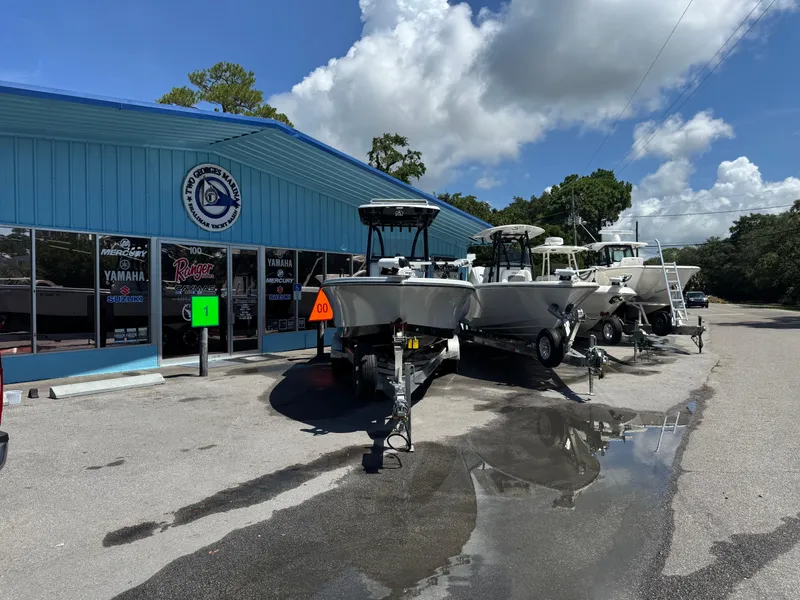 Slide: The Image of 2023 Blazer 2700 HYBRID BAY boat on trailer at marina. - 2
