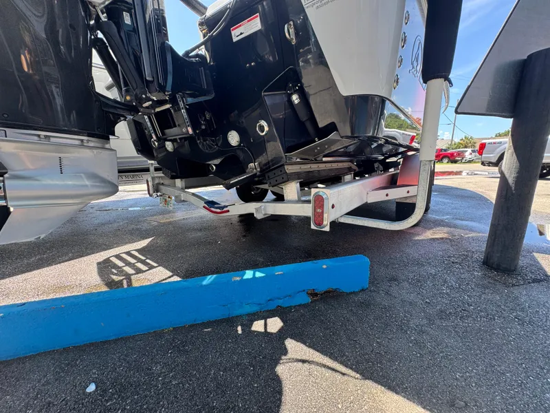 Slide: The Image of 2023 Blazer 2700 HYBRID BAY boat trailer detail in a parking area. - 24