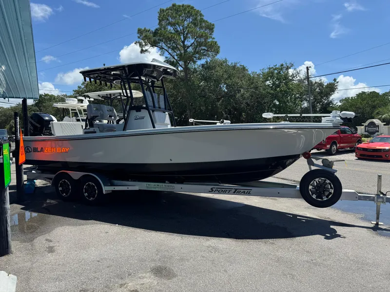 Slide: The Image of 2023 Blazer 2700 HYBRID BAY boat on trailer outside dealership. - 4