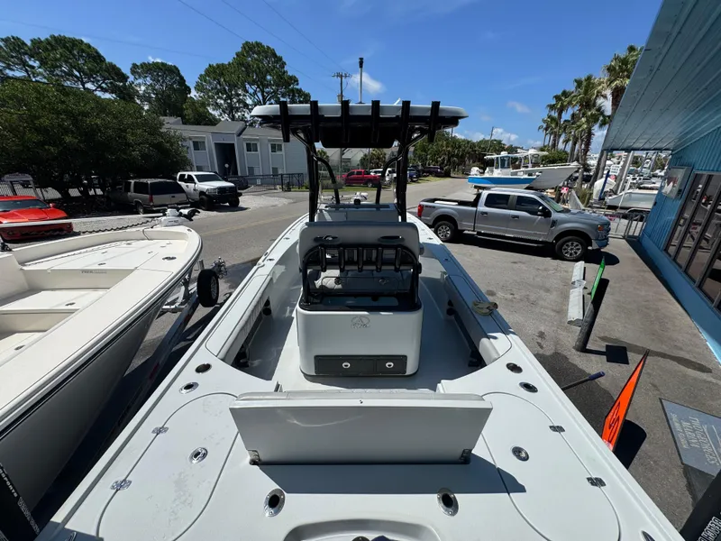 Slide: The Image of 2023 Blazer 2700 HYBRID BAY boat displayed outdoors on a sunny day. - 8