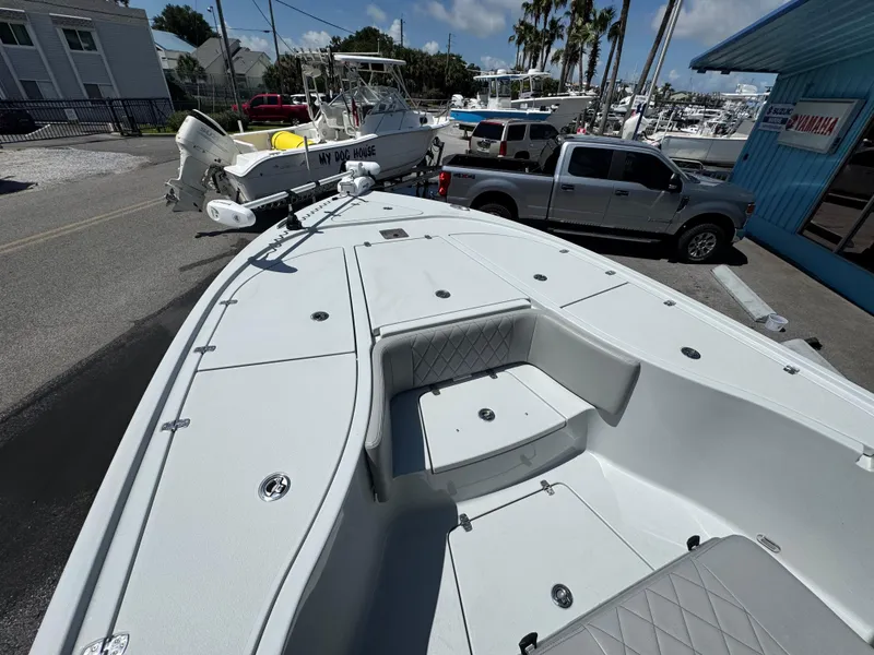 Slide: The Image of 2023 Blazer 2700 HYBRID BAY boat parked near trucks and other boats. - 9