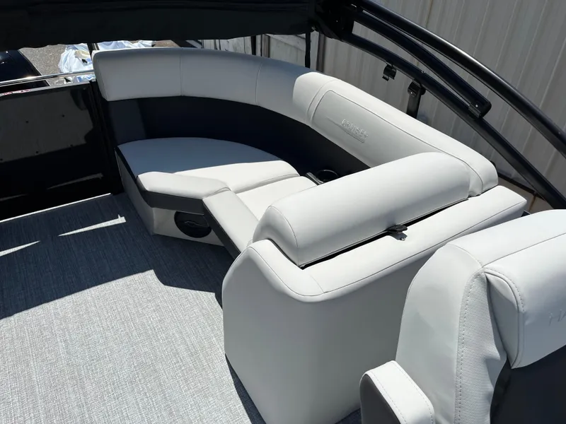 Slide: The Image of 2026 Harris Cruiser 210 boat interior with white seating and gray flooring. - 11