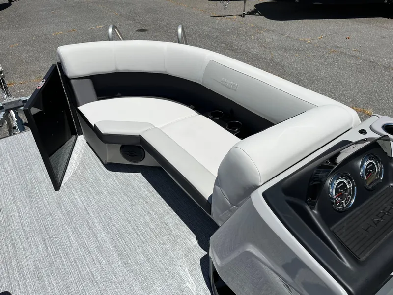 Slide: The Image of 2026 Harris Cruiser 210 boat interior with white cushioned seating and modern design. - 12