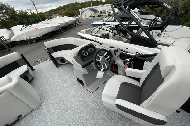 Slide: The Image of 2026 Harris Cruiser 210 boat interior with modern seating and steering console. - 23