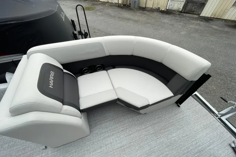 Slide: The Image of 2026 Harris Cruiser 210 boat seating with gray upholstery and cup holders. - 25