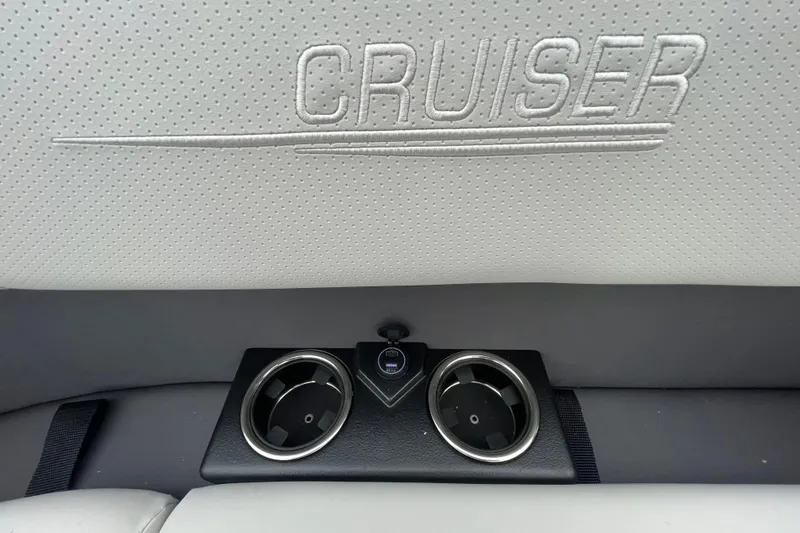 Slide: The Image of 2026 Harris Cruiser 210 interior with embossed logo and dual cup holders. - 26