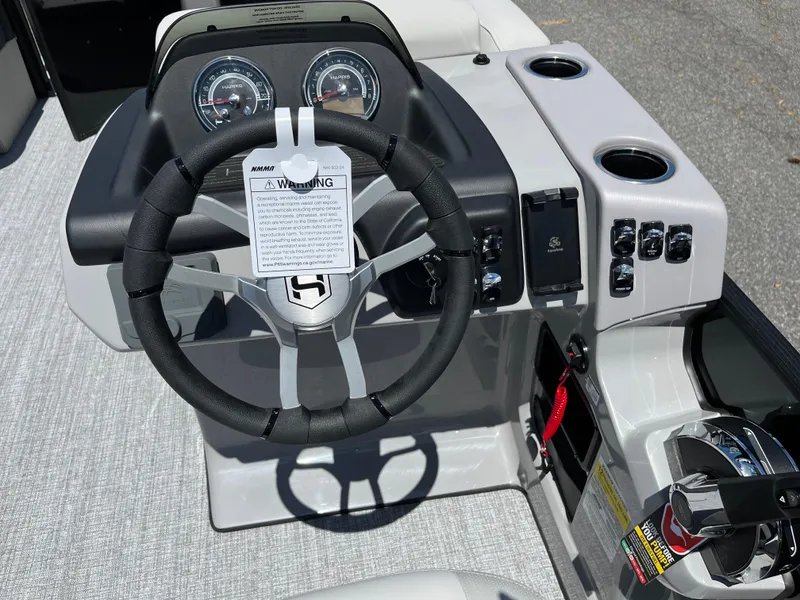 Slide: The Image of 2026 Harris Cruiser 210 boat dashboard with steering wheel and controls. - 6