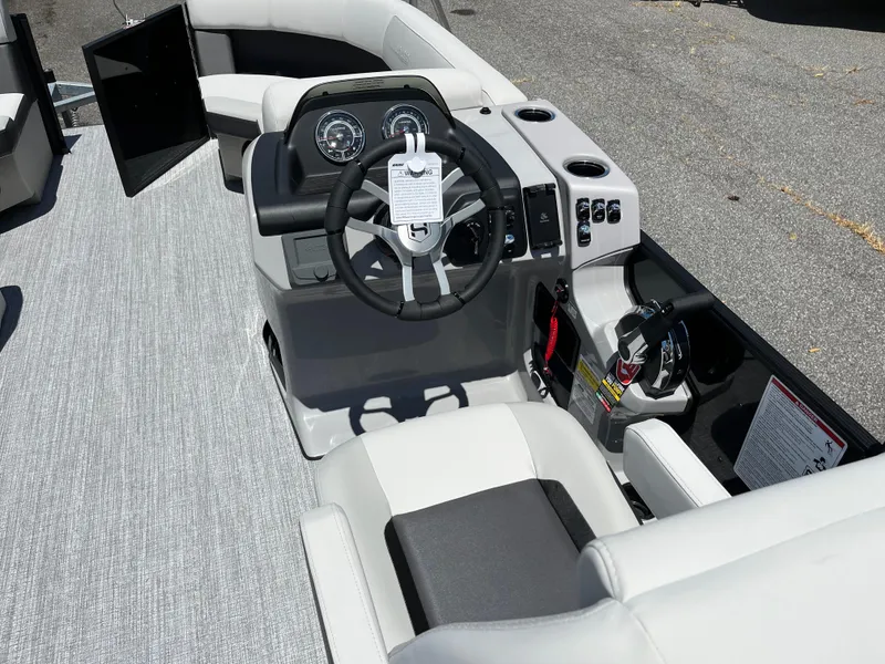 Slide: The Image of Steering console of 2026 Harris Cruiser 210 boat with gauges and controls. - 7