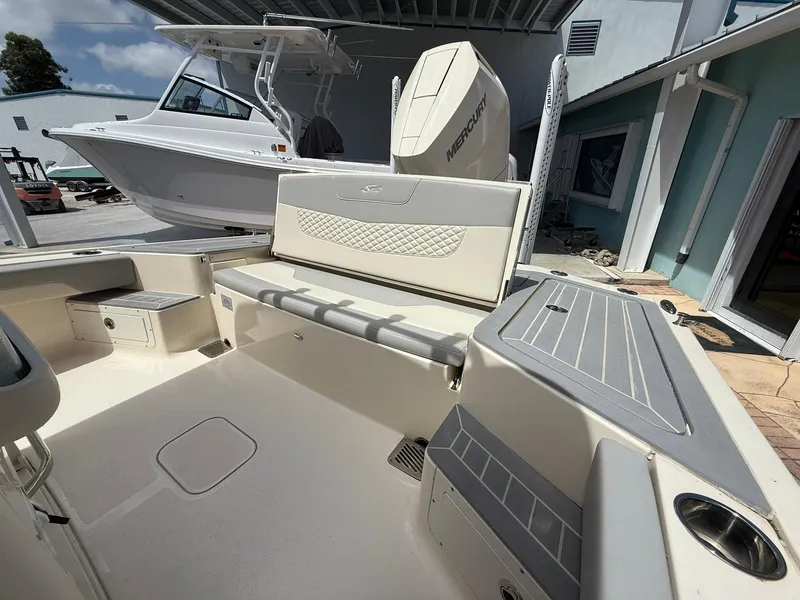 Slide: The Image of 2024 Scout 281 XSS boat interior with seating and Mercury engine. - 14
