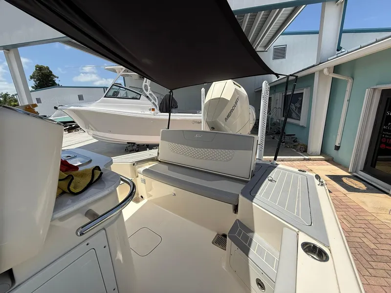 Slide: The Image of 2024 Scout 281 XSS boat interior with seating and Mercury engine. - 17