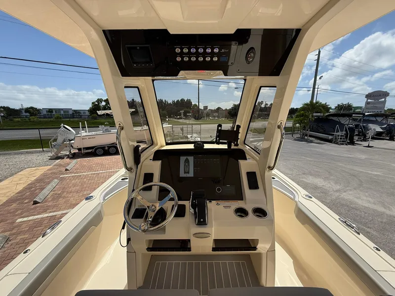 Slide: The Image of 2024 Scout 281 XSS boat cockpit with steering wheel and control panel. - 20