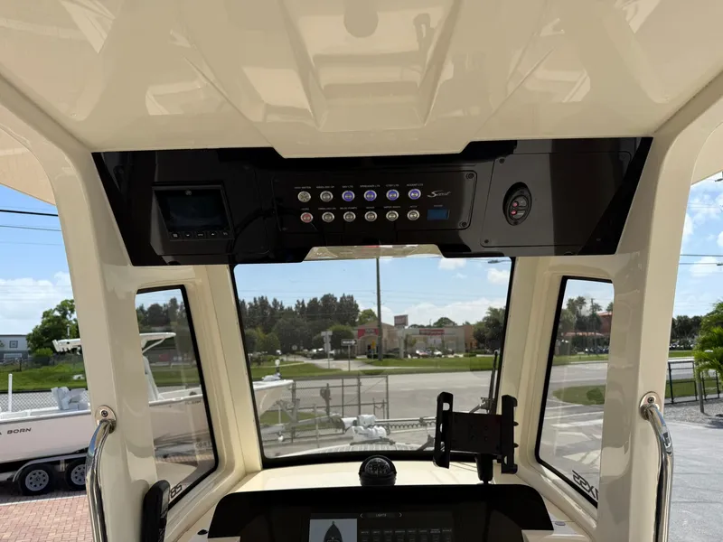 Slide: The Image of 2024 Scout 281 XSS boat dashboard with control panel and navigation equipment. - 21