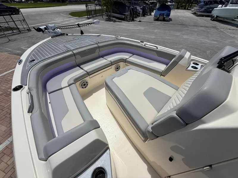 Slide: The Image of 2024 Scout 281 XSS boat interior with cushioned seating and modern design. - 29