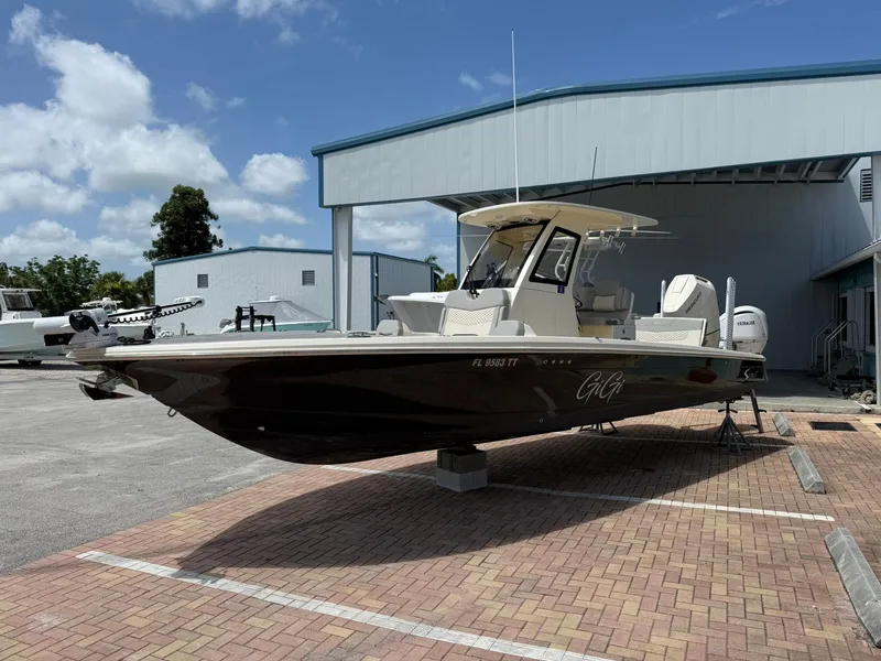 Slide: The Image of 2024 Scout 281 XSS boat displayed outdoors on a sunny day. - 3