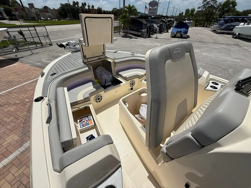 Slide: The Image of 2024 Scout 281 XSS boat interior with open storage compartments and seating. - 30