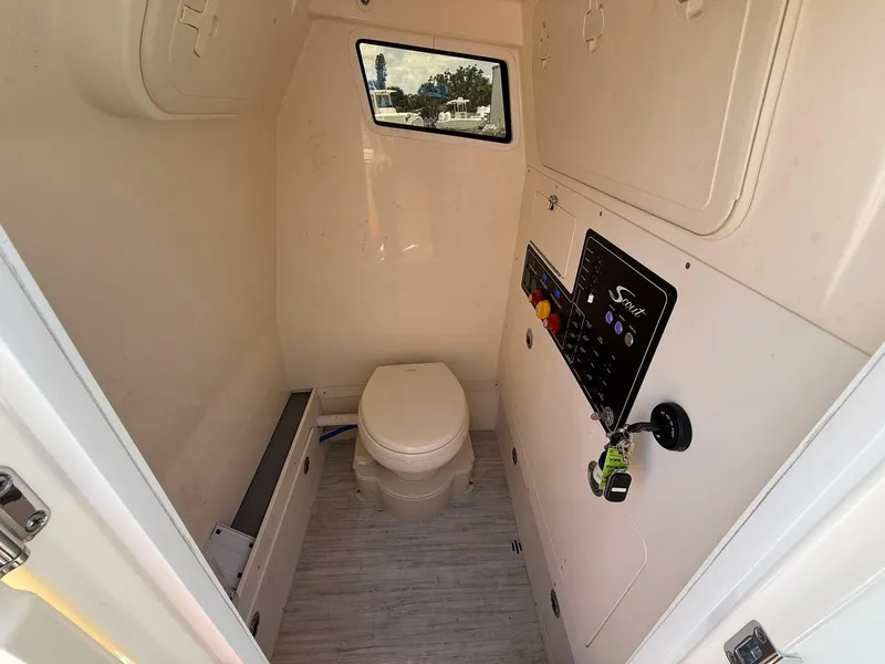 Slide: The Image of 2024 Scout 281 XSS boat interior with toilet and control panel. - 38