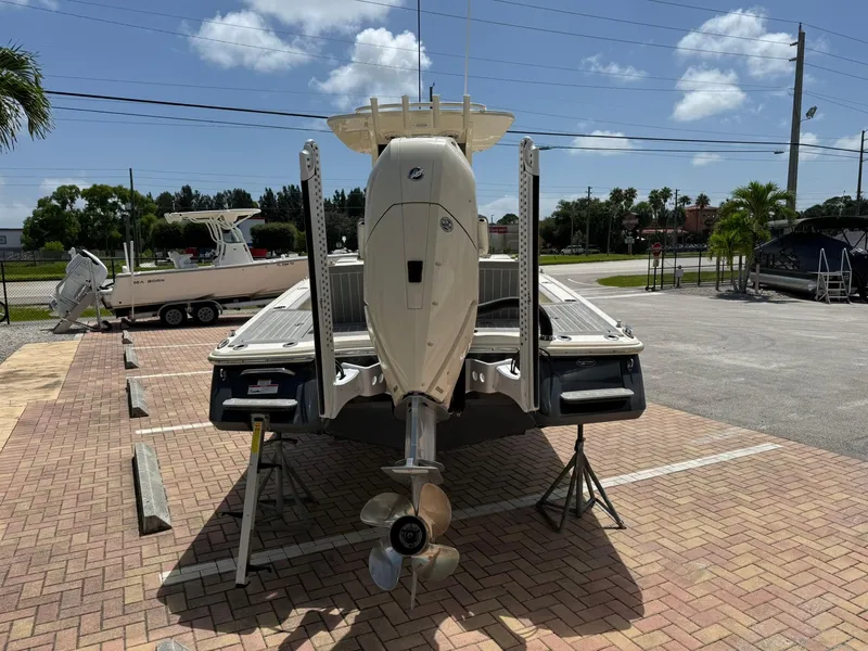 Slide: The Image of 2024 Scout 281 XSS boat on display in a parking lot under a clear sky. - 5