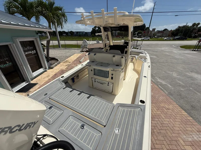 Slide: The Image of 2024 Scout 281 XSS boat with Mercury engine, docked near a sales office. - 9