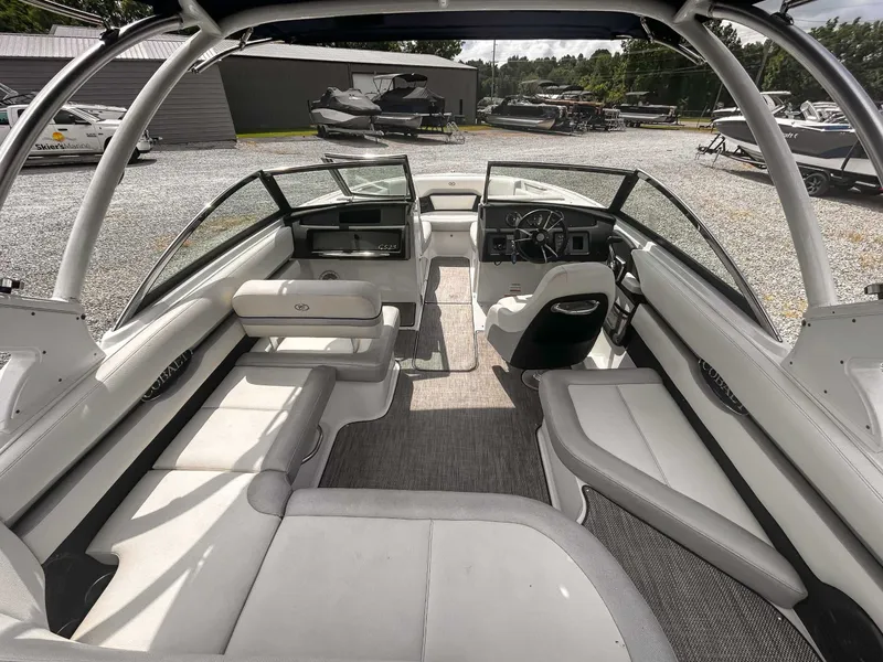 Slide: The Image of 2018 Cobalt CS23 boat interior with spacious seating and modern dashboard. - 10